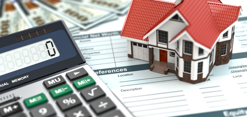 Calculator and small model house on top of paperwork