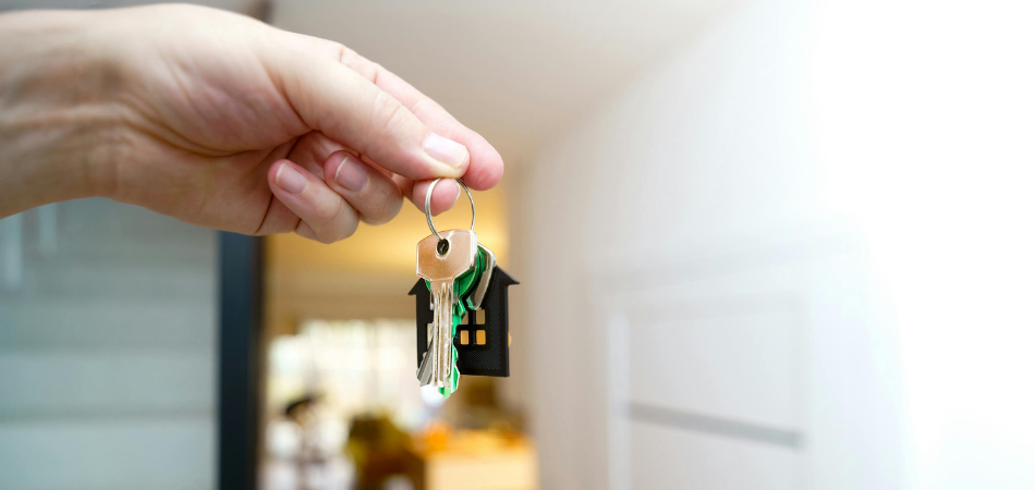 Hand holding house keys